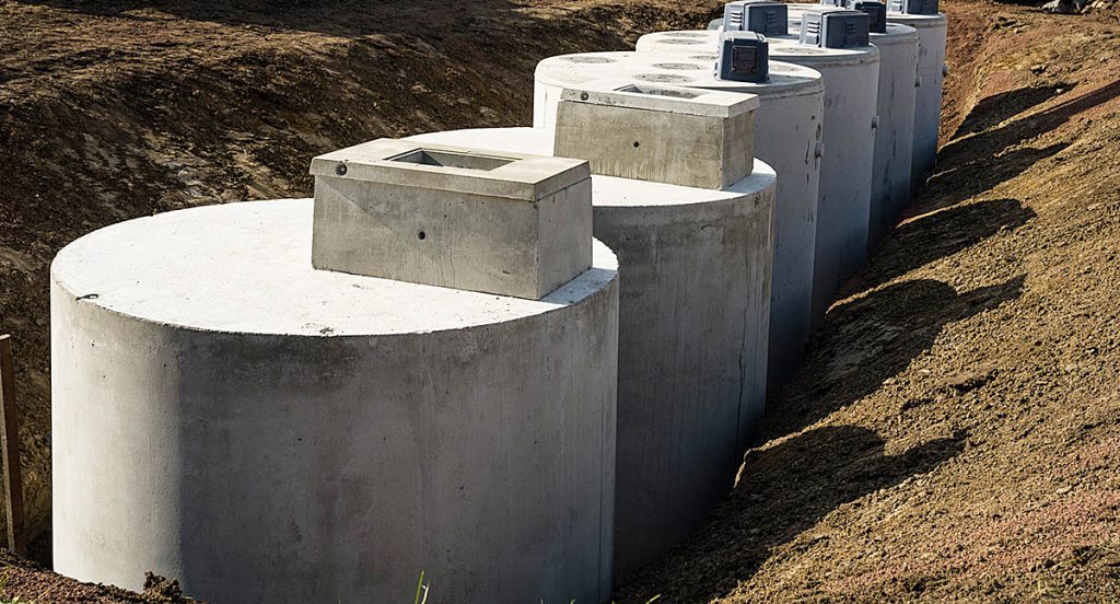 Several septic tank systems uncovered in the ground.