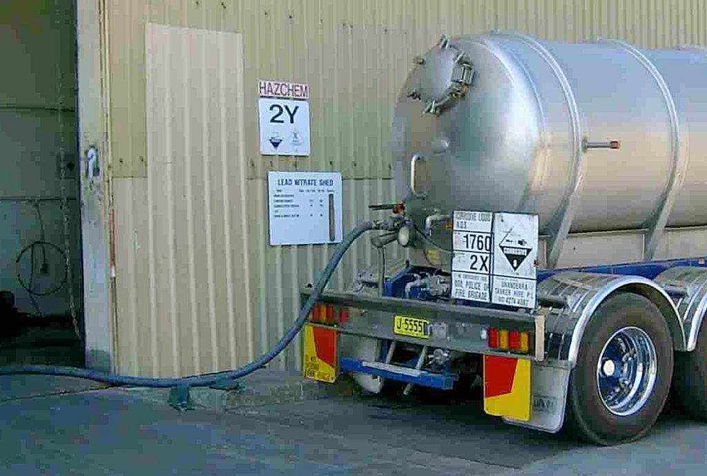 A vacuum loader truck at a business site.