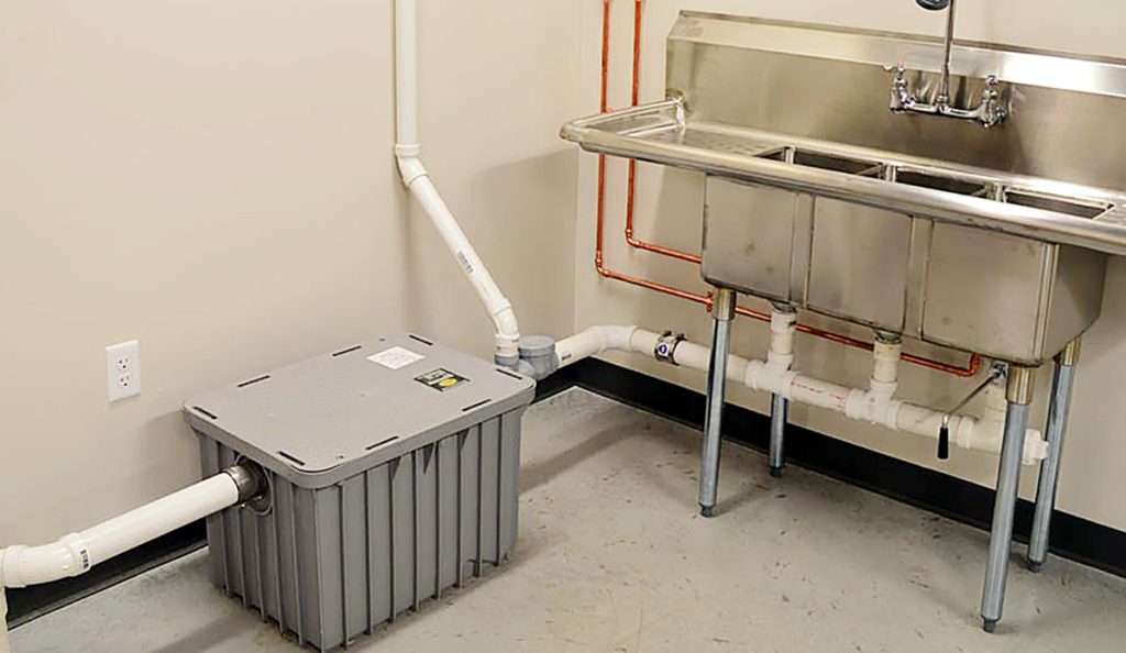 A grease trap and sink in a kitchen