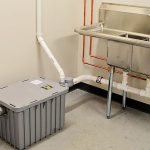 A grease trap and sink in a kitchen