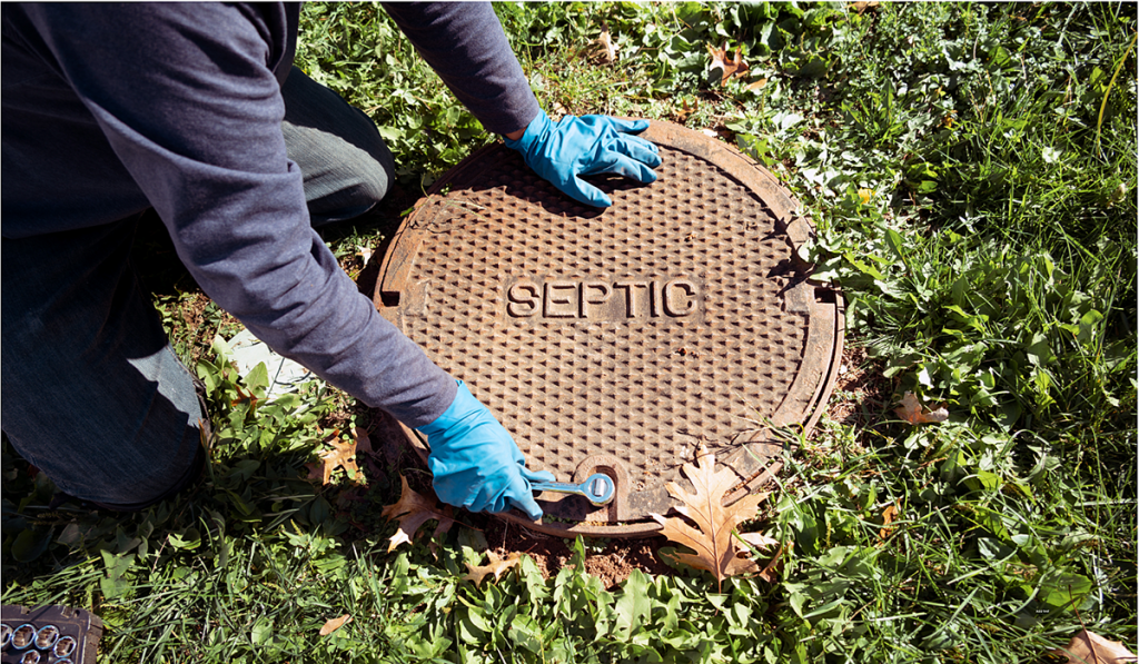 A person accessing a septic tank
