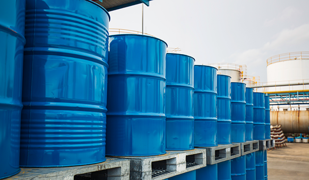 Rows of blue metal barrels, stacked up outside