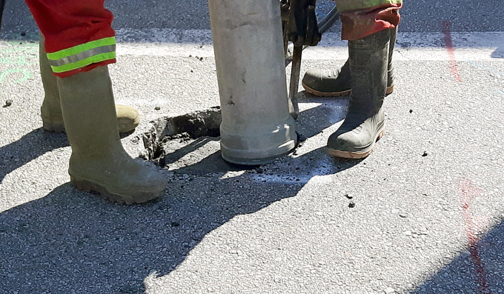 Vacuum excavation equipment safely exposing underground services on a civil construction site.