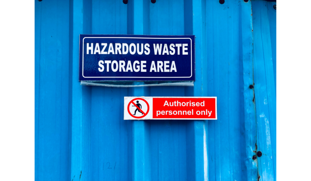 Hazardous waste storage area with authorised personnel signage