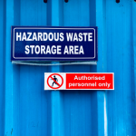 Hazardous waste storage area with authorised personnel signage