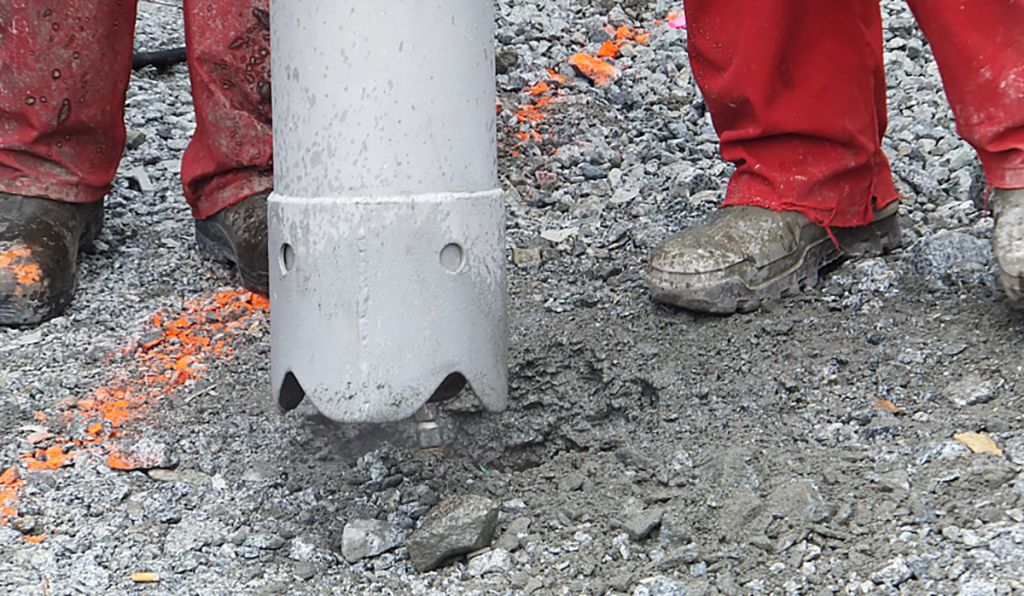 Workers using vacuum excavation equipment to expose underground services