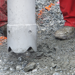 Workers using vacuum excavation equipment to expose underground services